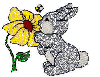 rabbit smelling a flower